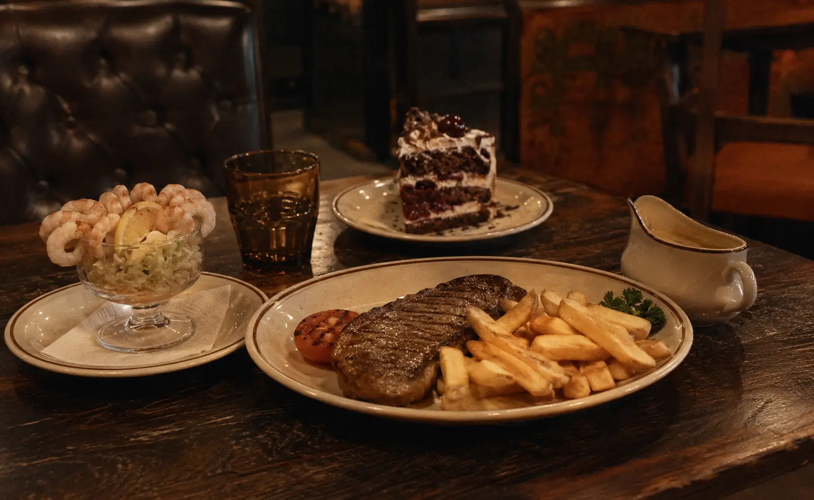 Editorial reconstruction of a 1970s steakhouse table set for a three-course meal