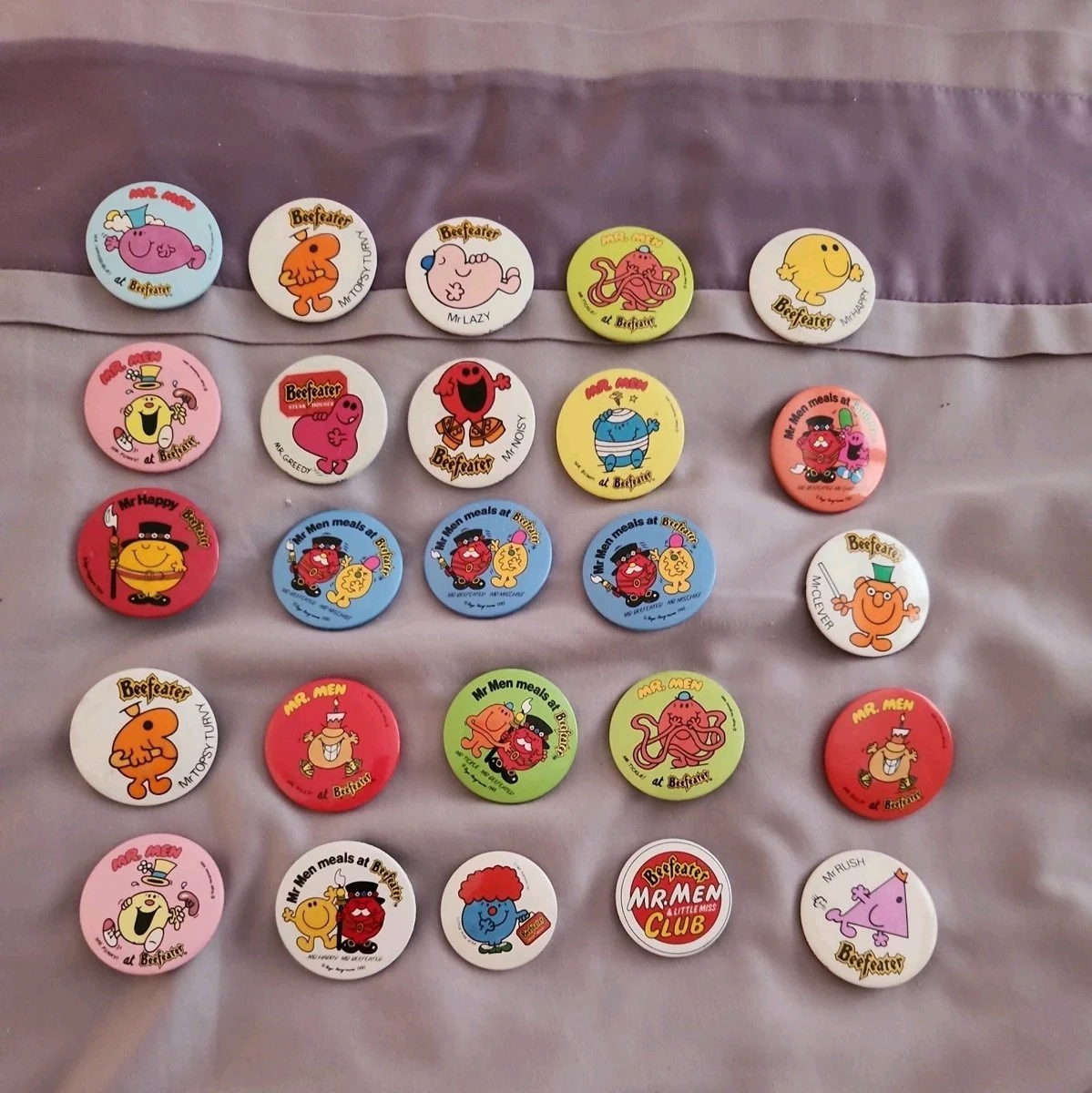 A collection of 24 Mr Men Beefeater badges