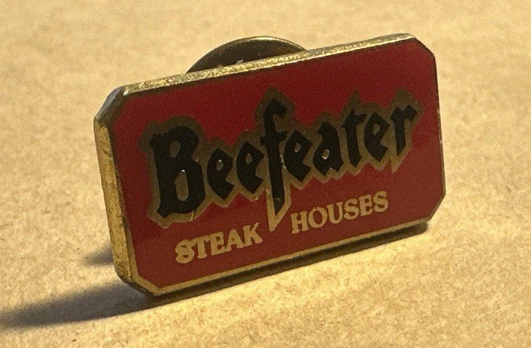 Red 'Beefeater Steak Houses' staff badge